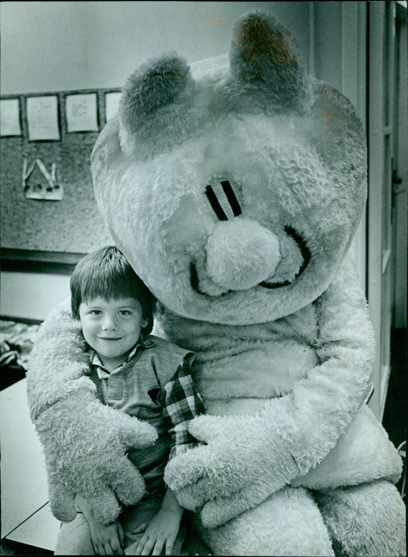 A cat gives a hug to Gary Harris at West Woon Farm First School. - Vintage Photograph