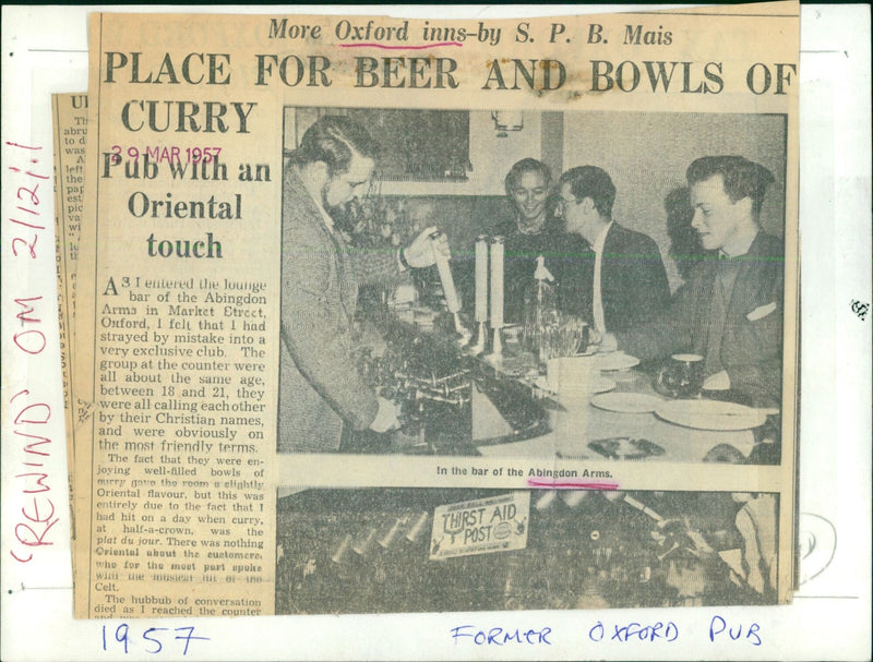 A group of friends enjoy a bowl of curry in the bar of the Abingdon Arms in Oxford, England. - Vintage Photograph