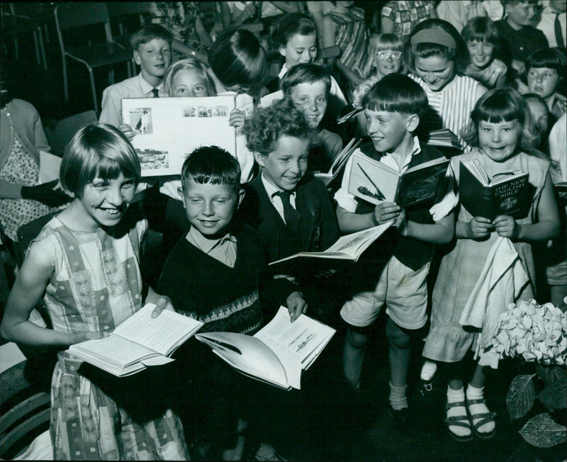 Students at a school in Oxford, England, looking at a copy of the King James Bible from 1611. - Vintage Photograph