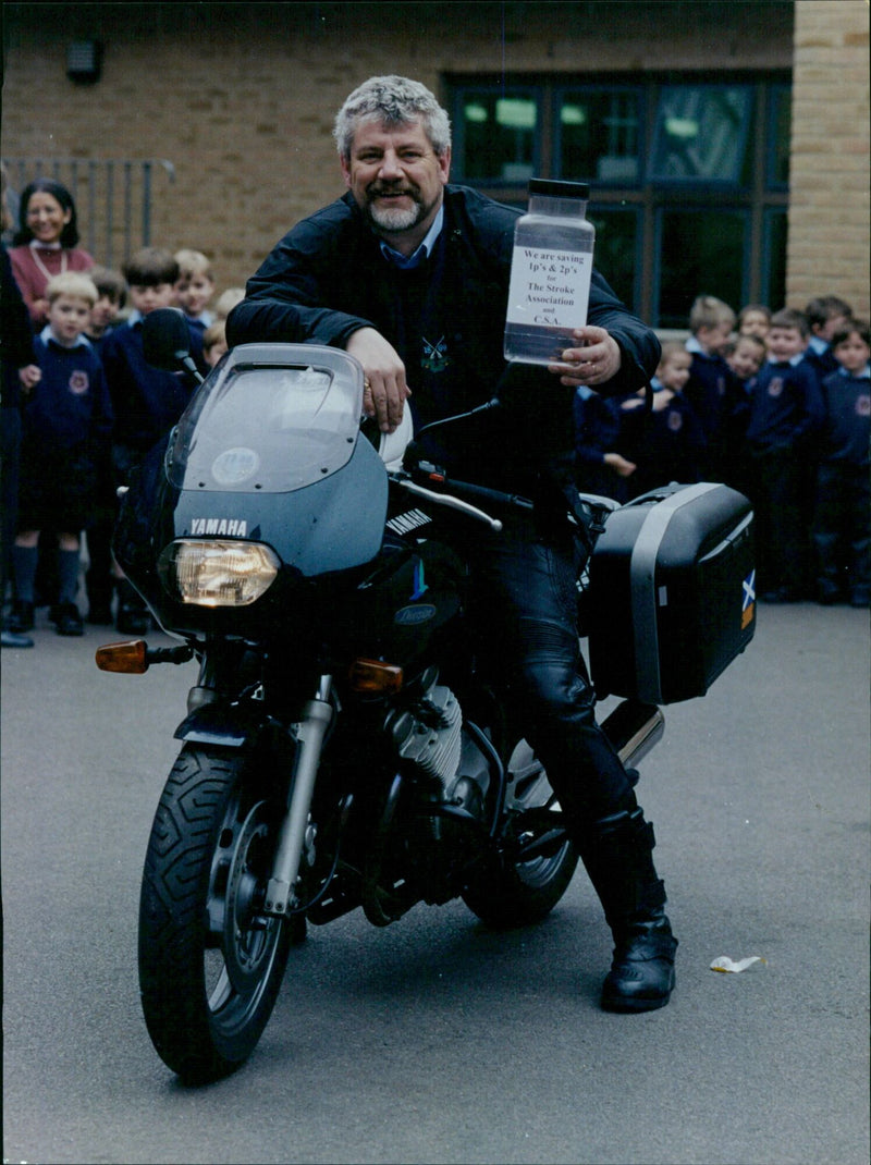 Yamaha Mottram, head of Ch Ch Cathedral School, shows his motorbike to pupils at Oxford Ox Schools. - Vintage Photograph