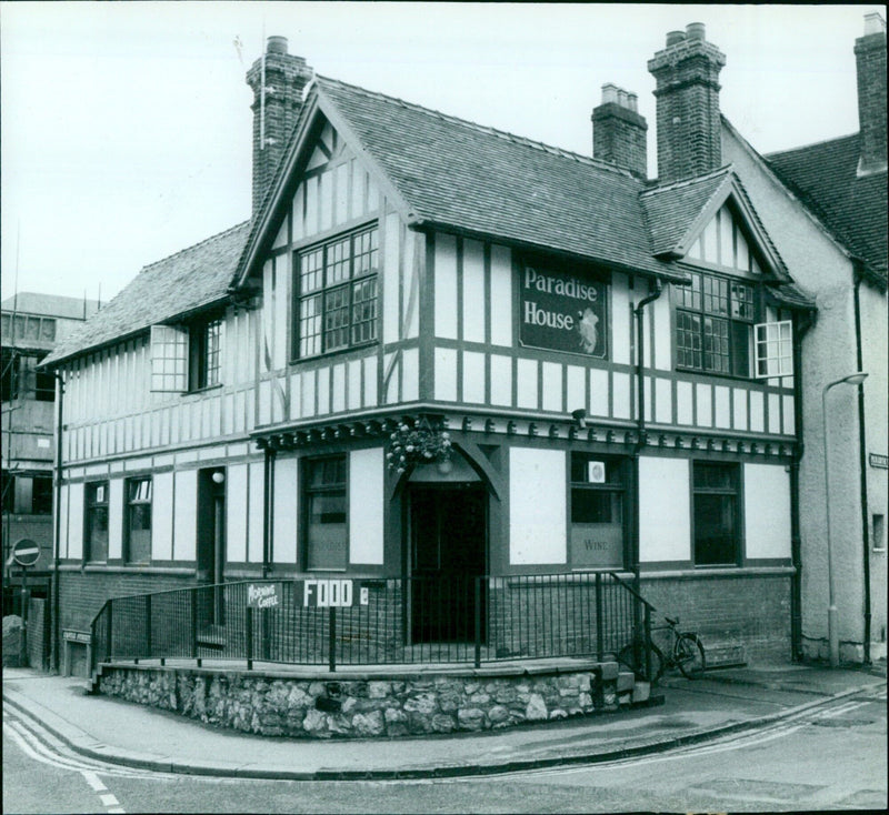 A man enjoying a morning coffee and food at Paradise House. - Vintage Photograph