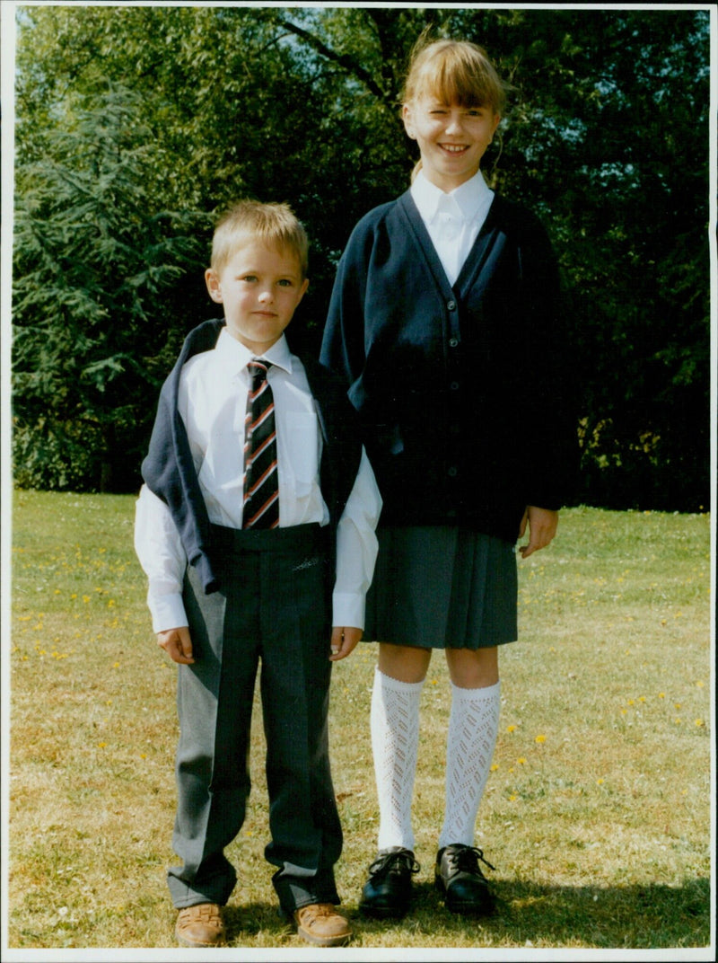 Students in school uniforms pose for a fashion shoot in Central. - Vintage Photograph