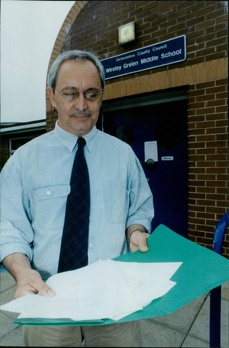 Paul Reast, headteacher of Wesley Green Middle School, is seen in front of the school on the day of its closure. - Vintage Photograph