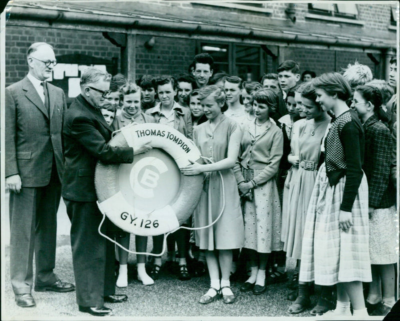 Mr. H. Croft-Baker presents a trawler's life-ring to Headington Secondary School at a prize-giving ceremony. - Vintage Photograph