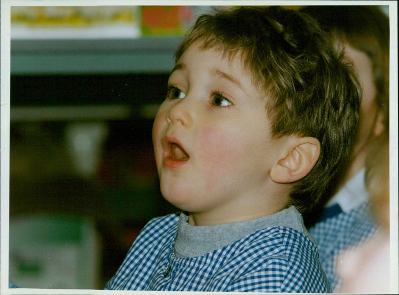 Headington Junior School author Shen Roddie reads 'Chickenpox' to Charles Arbridge, 4, and Leila Zobeiat, 5. - Vintage Photograph