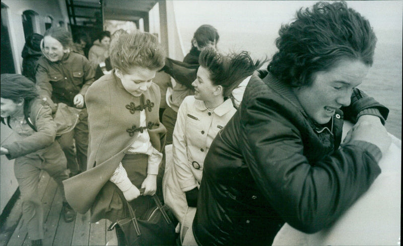 A group of people crossing a windy street in France. - Vintage Photograph