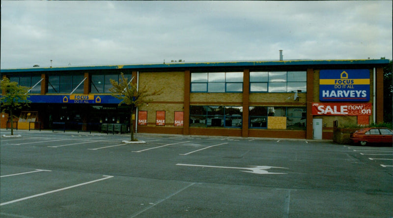 Customers enter and exit the Focus Do It All store in Oxford, England. - Vintage Photograph