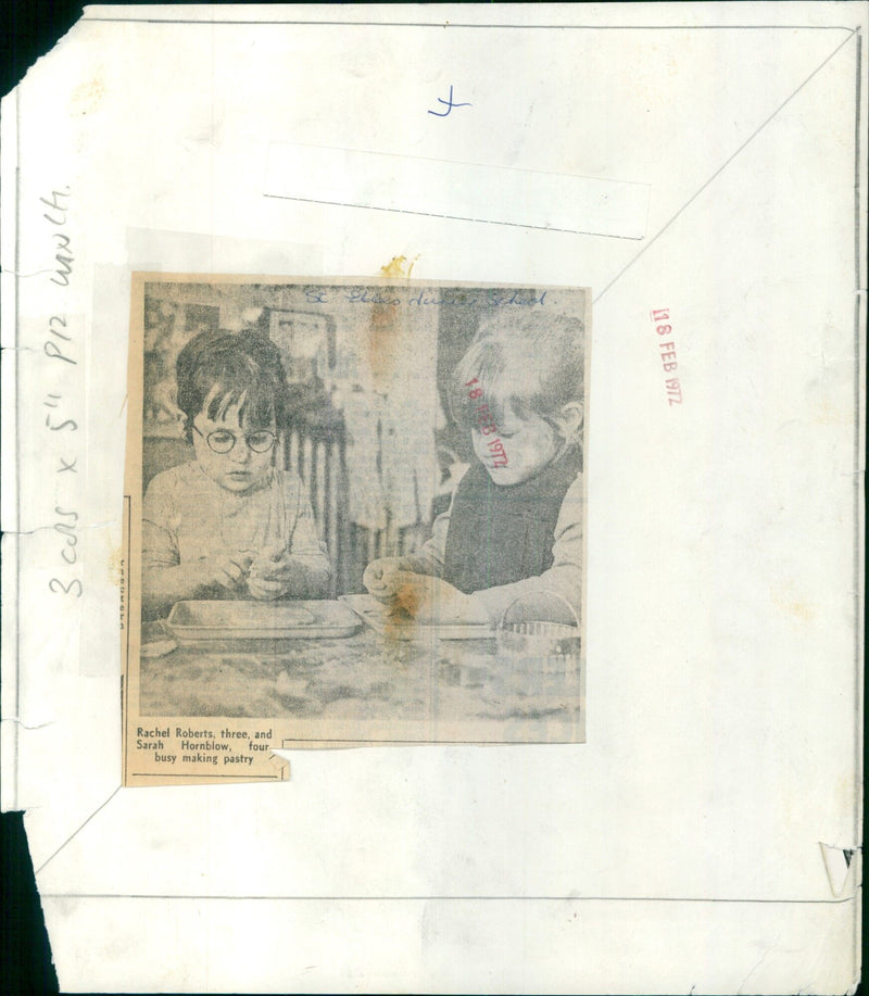 Rachel Roberts, 3, and Sarah Hornblow, 4, making pastry with their grandmother. - Vintage Photograph