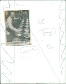 Musician John Pusey plays the bonangs at the Bate Collection of Musical Instruments. - Vintage Photograph