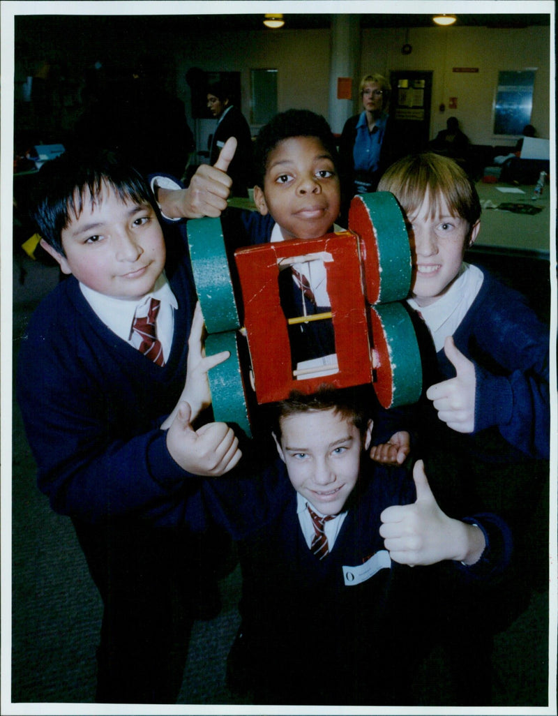 Two Headington Middle School students proudly show off their handmade racing car made from recycled materials at the Temple Cowley School in Oxford. - Vintage Photograph