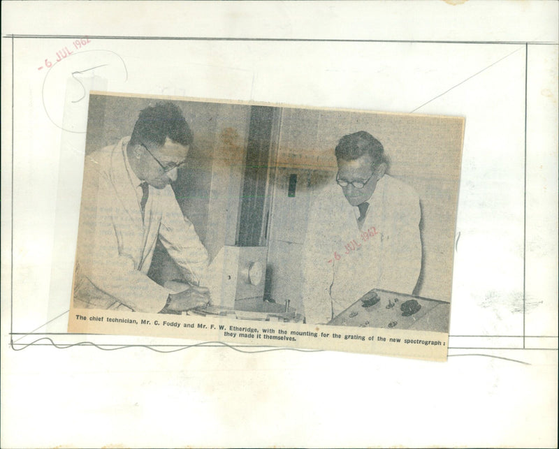 Technicians C. Foddy and F. W. Etheridge assemble the grating for a new spectrograph. - Vintage Photograph