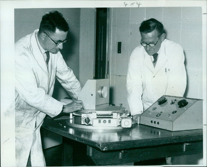 Technicians C. Foddy and F. W. Etheridge assemble the grating for a new spectrograph. - Vintage Photograph