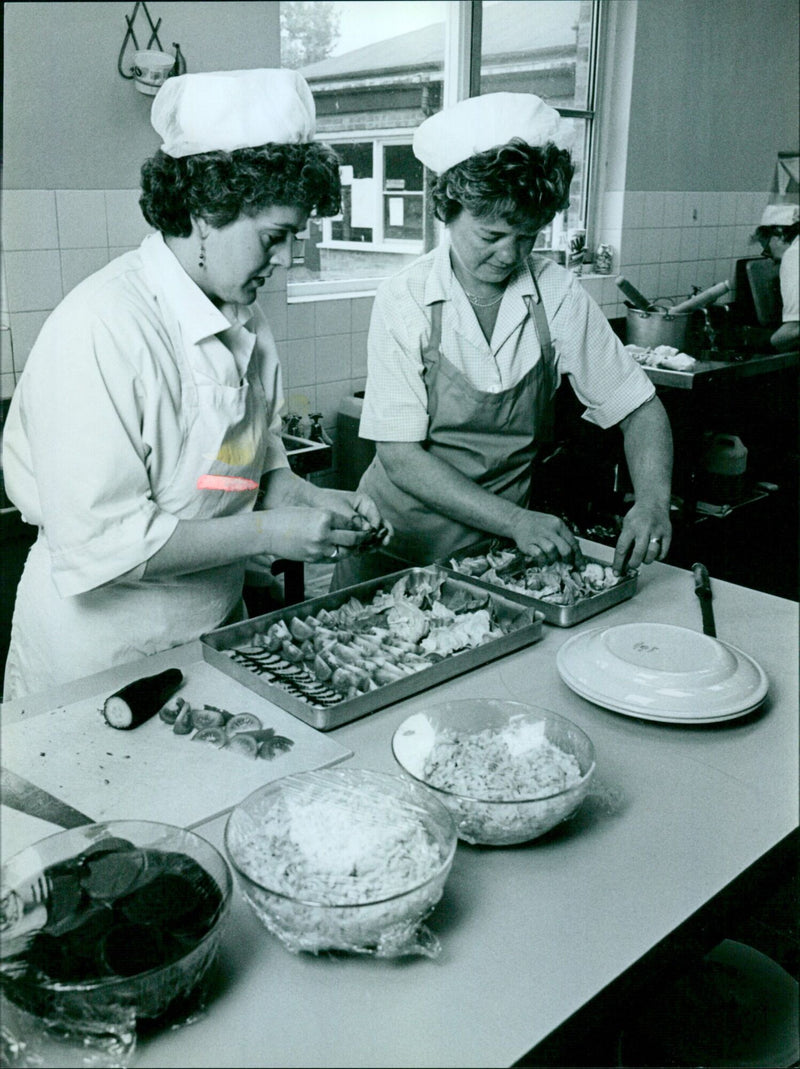 Jean and Jenny prepare a salad in the kitchen. - Vintage Photograph