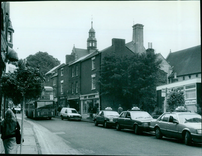 A series of Oxford buildings, including a fire station, taxicabs, and a housing aid centre. - Vintage Photograph