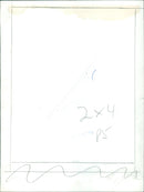 A man sawing a 2x4 plank of wood. - Vintage Photograph