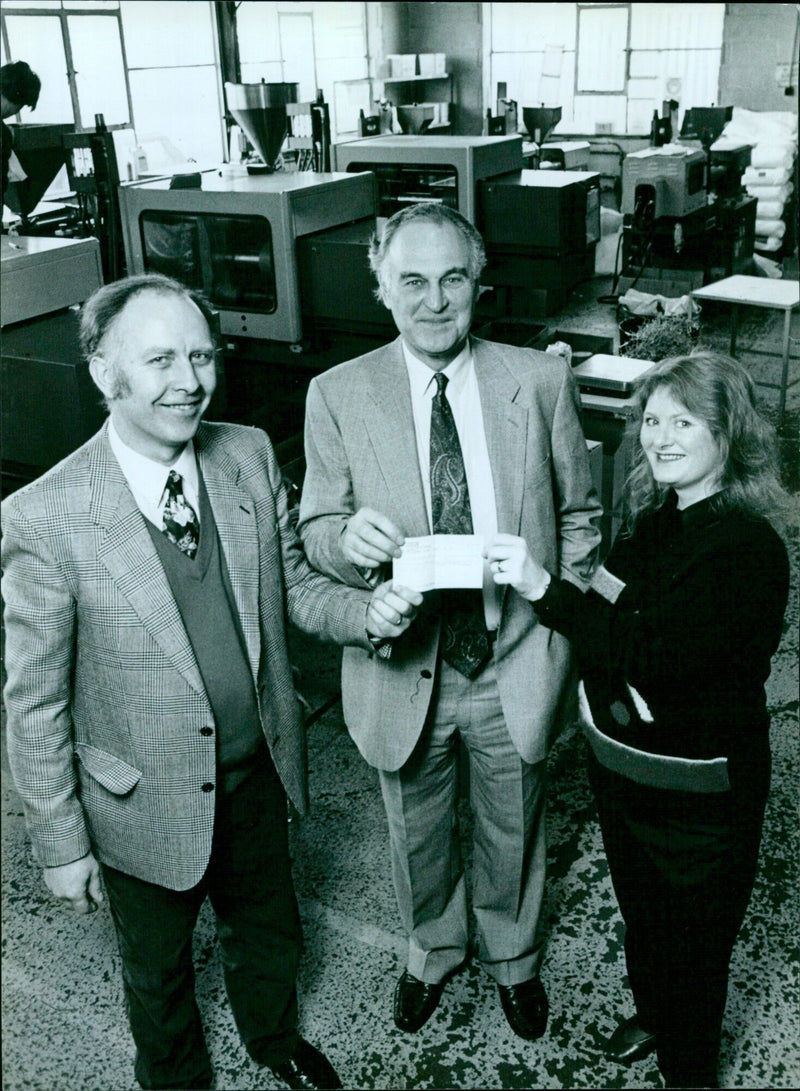 David and Roberta Allen, Directors of County Industries, present a cheque to Kim Hills Spedding, Director of the Thames Business Advice Centre. - Vintage Photograph