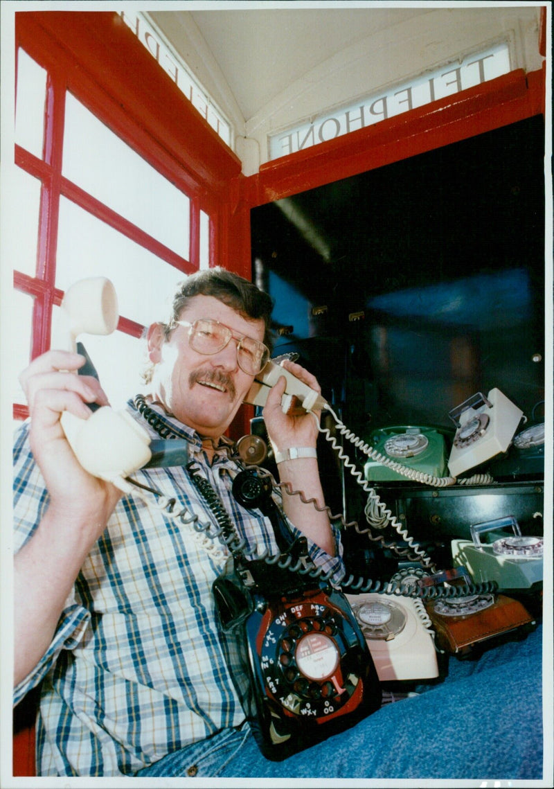 Robert Tarrant, a phone fanatic, proudly displays his collection of 180 telephones. - Vintage Photograph