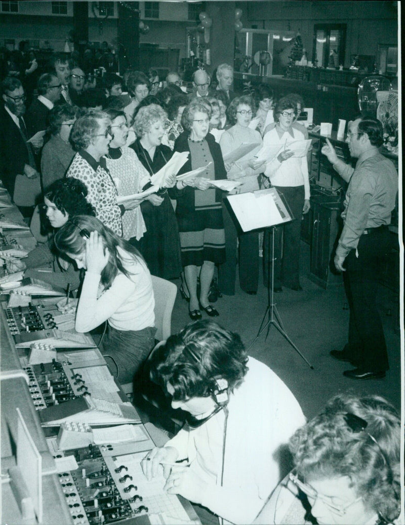 A group of carolers sing at the Telephone Exchange in Speedwell Street, Oxford. - Vintage Photograph