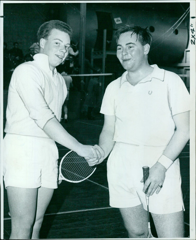 Cambridge captain T. W. Mairyne (Methodist College, Belfast, and St. Catharine's) congratulates Oxford captain A. H. Pearmain (City of London and Keble) after winning the Inter-University badminton match at Abingdon on Saturday. - Vintage Photograph