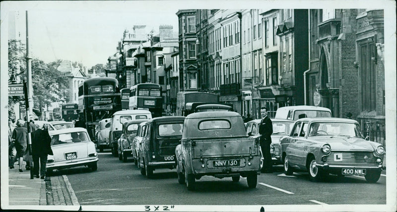 A view of Entry Eway Street in Oxford, England, with Tyre Supplies, Laring Aids, and High Street seen in the background. - Vintage Photograph