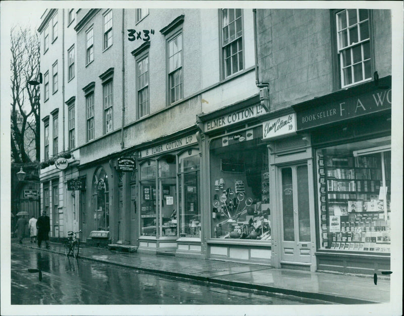 Local businesses line a street in Oxford, England. - Vintage Photograph