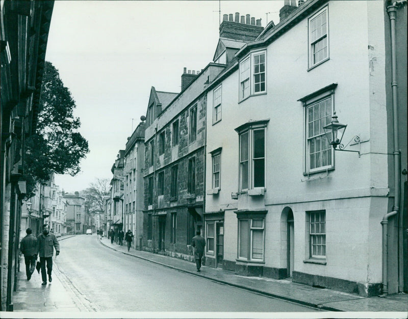 A man enjoying a lunch with a friend in Holywell Street, Oxford. - Vintage Photograph