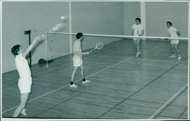 Four St. Catharines College students practice badminton. - Vintage Photograph