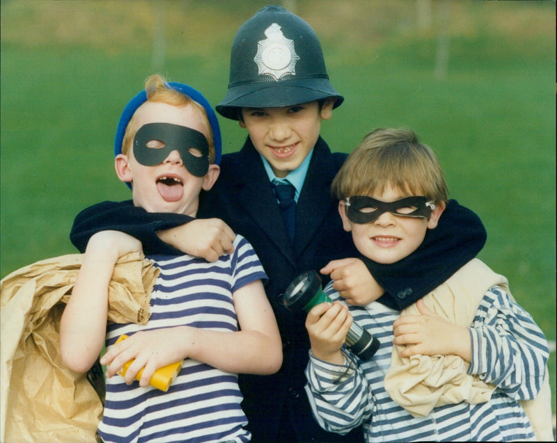 Oxford Police Officer Abdul Alnajafi arresting robbers Peter Rose and William McCready during 1st School Book Week Fancy Dress. - Vintage Photograph