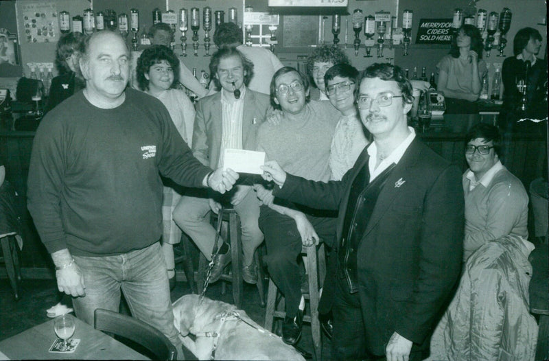 Dave Bourton presents a cheque to Neil Davis to help send a group of disabled people on a holiday to Scotland. - Vintage Photograph