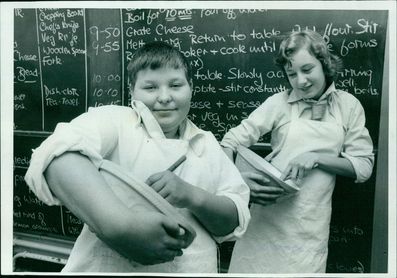 Brian Smith and Judith Cooper making a meal together. - Vintage Photograph