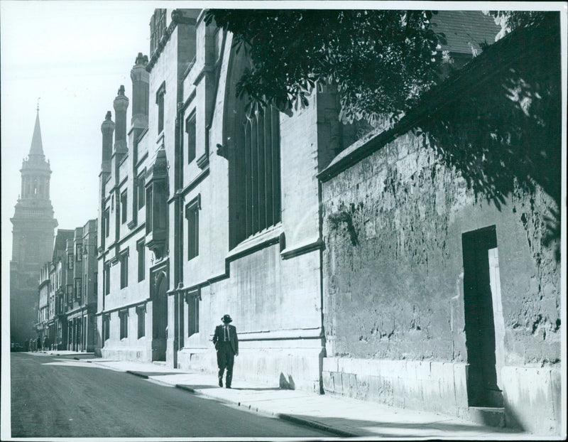 A woman walking down a street in Oxford, England. - Vintage Photograph