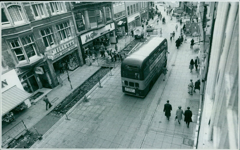 A test drive of a car outside a Pearl Queen Street store in Oxford, England. - Vintage Photograph