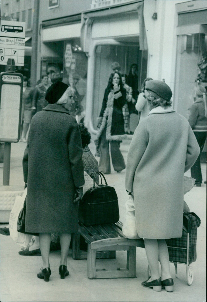 Passengers waiting at a bus stop in Oxford. - Vintage Photograph