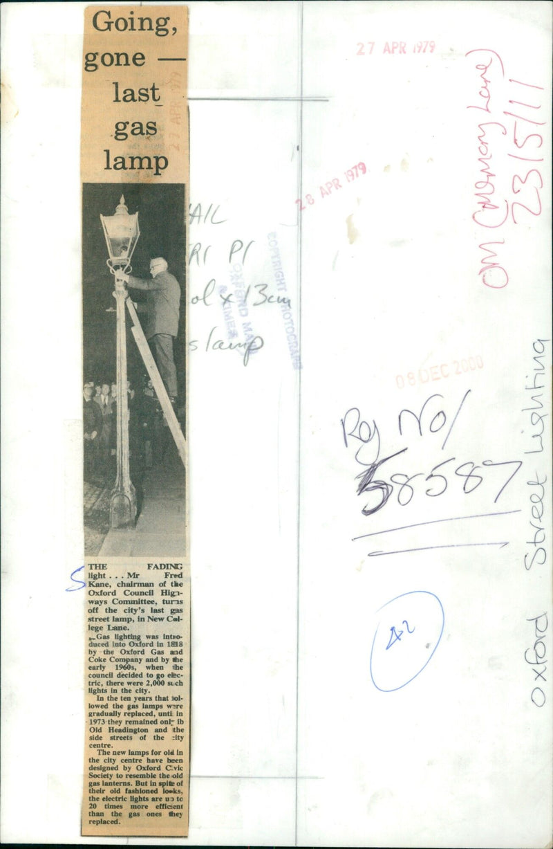 Fred Kane, Chairman of the Oxford Council Highways Committee, turns off the last gas street lamp in Oxford, England. - Vintage Photograph