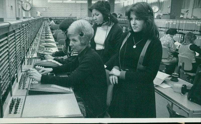 Sharon Miller and Brenda Russell, both 15, observe the operations of a telephone exchange in Speedwell Street. - Vintage Photograph