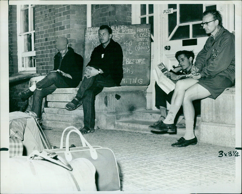 People wait outside Oxford's Youth Hostel two hours before its opening. - Vintage Photograph