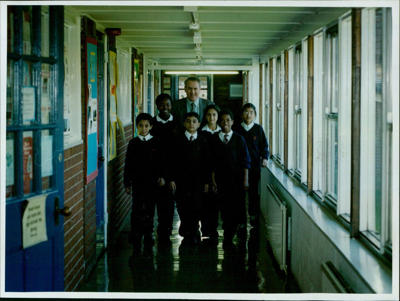 Temple Cowley School Headteacher Martin Thomas with pupils on September 10, 2001, celebrating new funding for teaching ethnic minorities. - Vintage Photograph