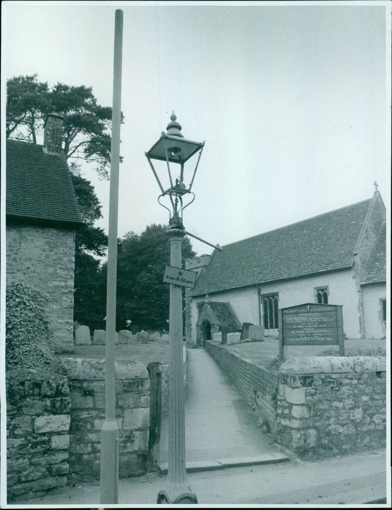 The old and new lamp stand side by side in Beauchamp Lane in Church Cowley. - Vintage Photograph