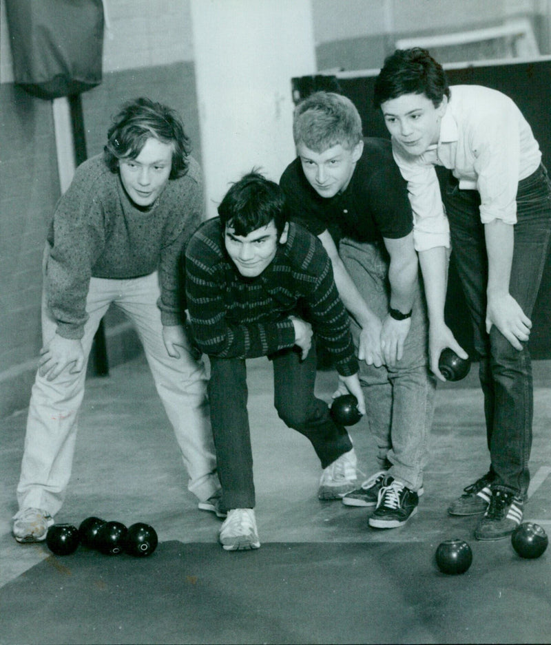 Four teenage boys play bowls in the sunshine near Wallingford, Oxfordshire. - Vintage Photograph