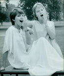 A model presents a dress from the DON J10 M5/3 fashion collection during a fashion show. - Vintage Photograph