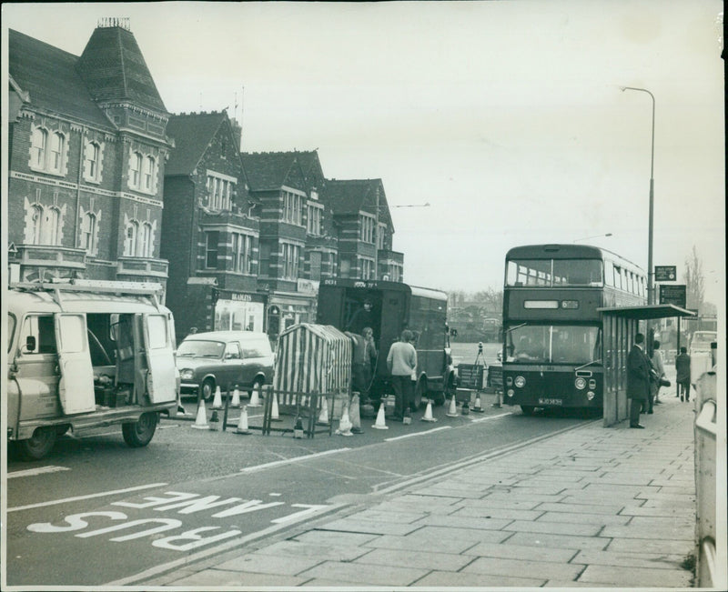 Post Office engineers carrying out cable work near a bus stop at an old LMS railway station in Park End Street. - Vintage Photograph