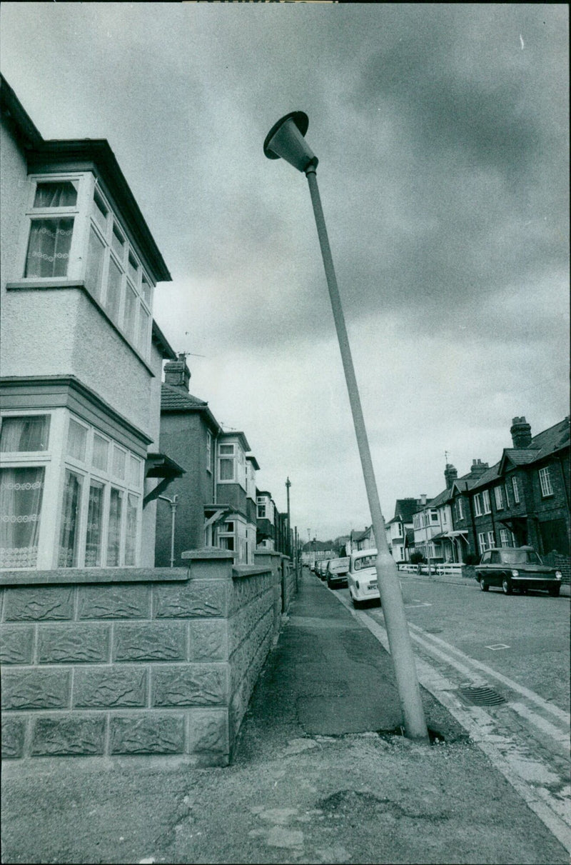 A damaged street lamp leans precariously on a post in West Oxford. - Vintage Photograph