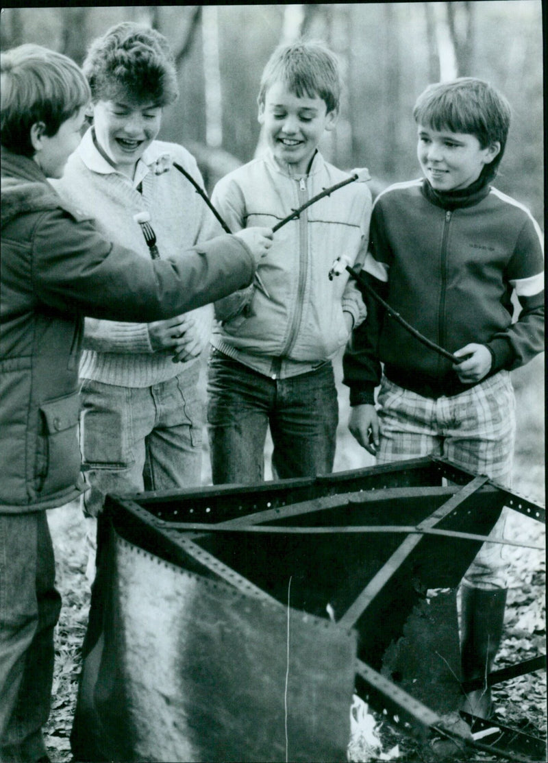 Four friends enjoy toasted marshmallows over a campfire at Youlbury. - Vintage Photograph