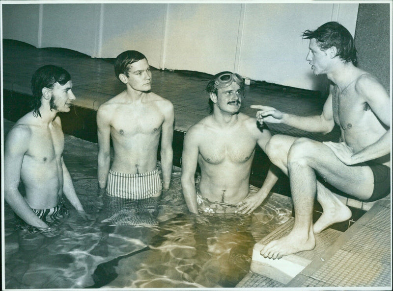 Oxford University Swimming Club captain Eric Thomson speaks with team members Walter Moberley and Eric Hanson after practice. - Vintage Photograph