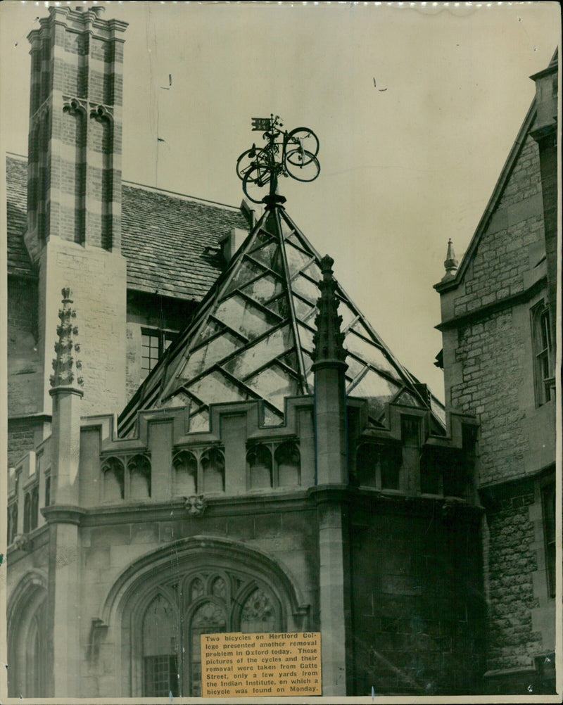 Two bicycles being removed from Hertford College in Oxford, England. - Vintage Photograph