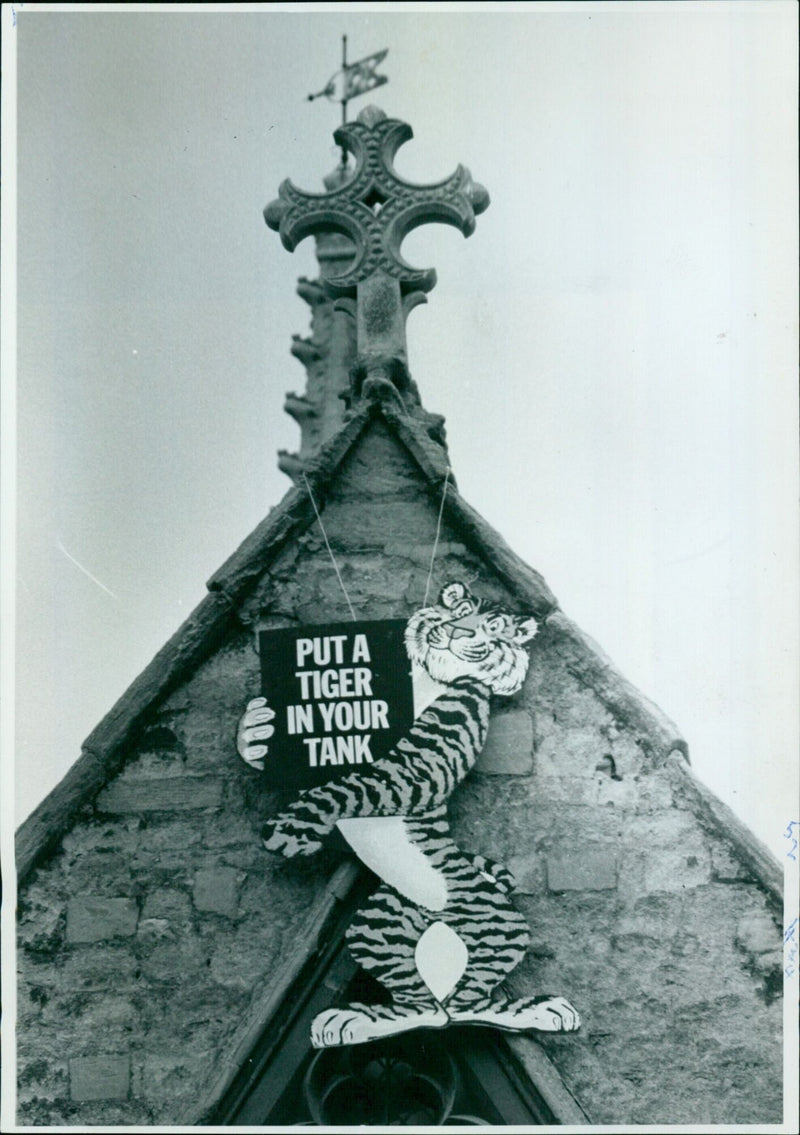 Students from Oxford University hang a sign reading "Put a Tiger in Your Tank" on Merton College Chapel. - Vintage Photograph