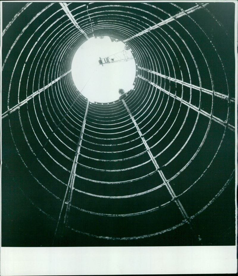 Workers inspect the bottom of a tunnel shaft at St. Aldates in Oxford, England. - Vintage Photograph