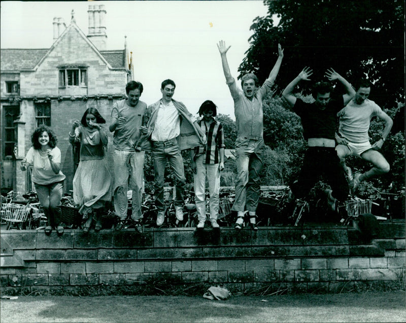 A group of young people wearing masks perform a dance during Keble College's Twelfth Night celebration on June 23, 1984. - Vintage Photograph