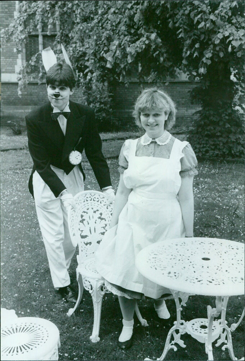 Oxford University students enjoy a "Mad Hatter's Tea Party" complete with jelly, strawberries, and tea. - Vintage Photograph