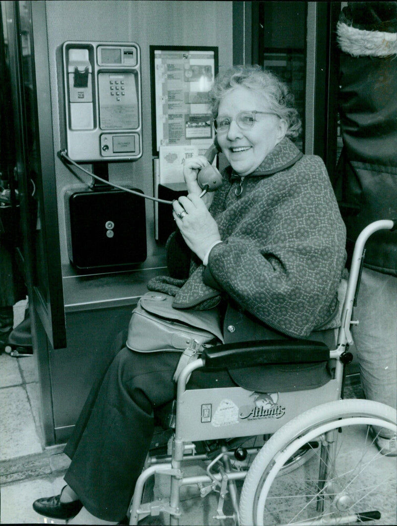 Peggy Hitchins christens a new phone booth in Commarket. - Vintage Photograph